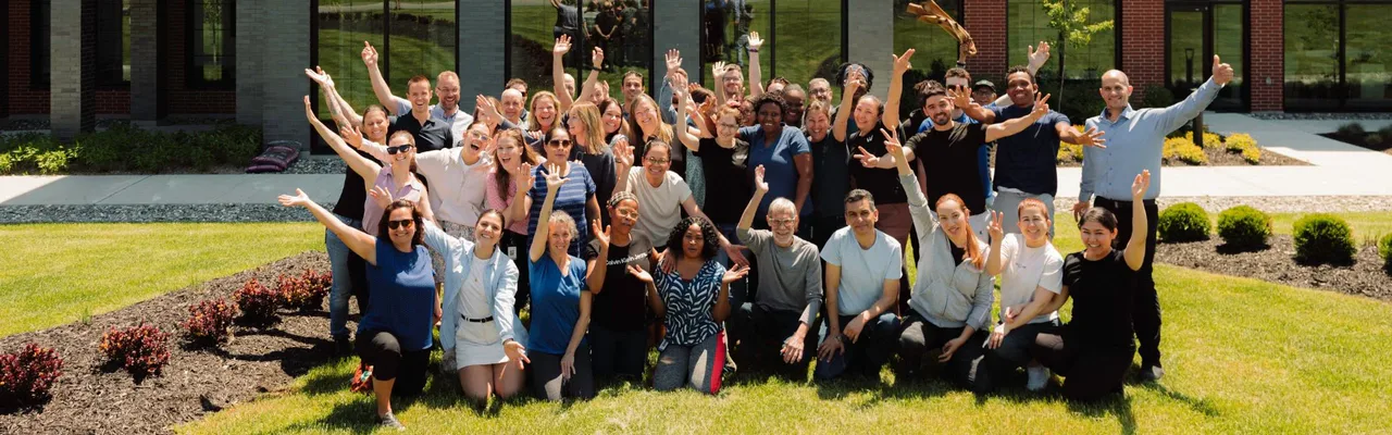 Café William team members posing together outside a building