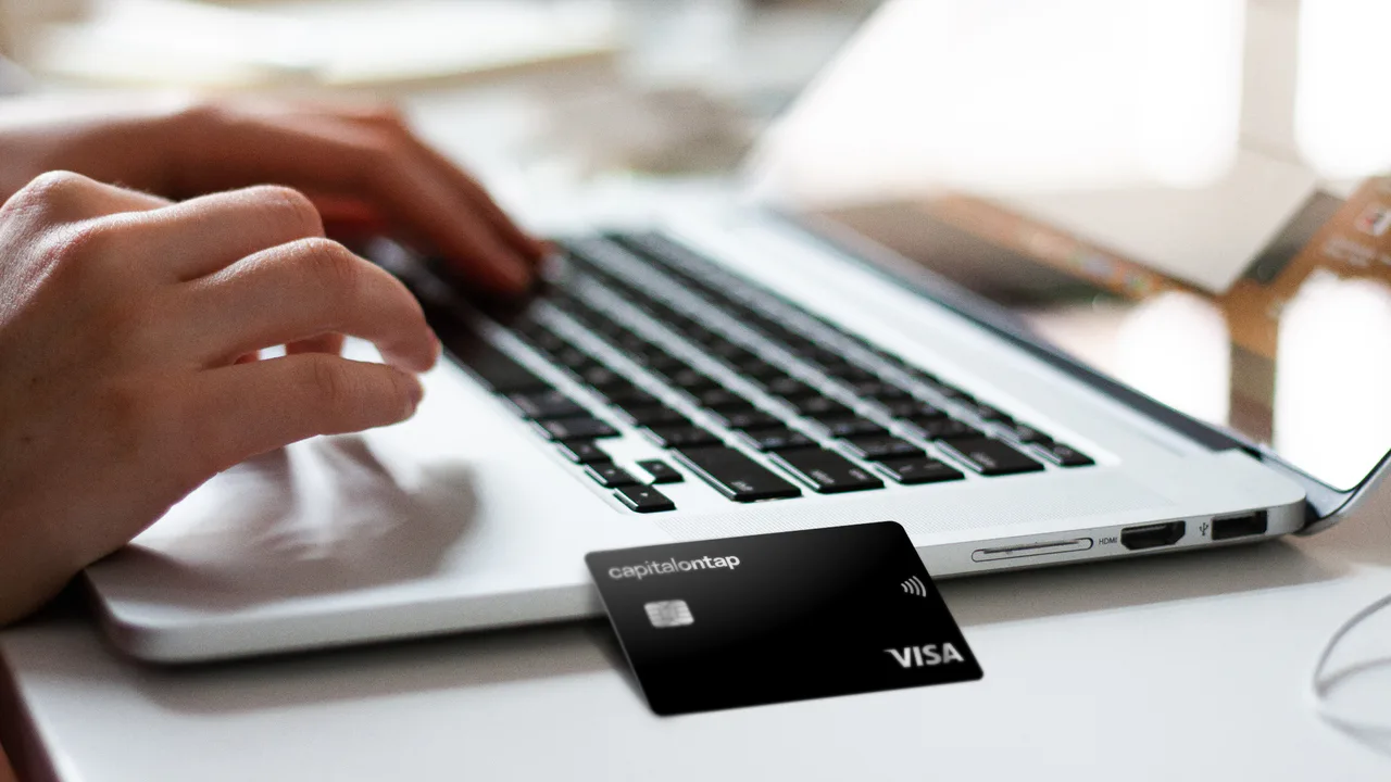 Capital on Tap business credit card beside a laptop in use