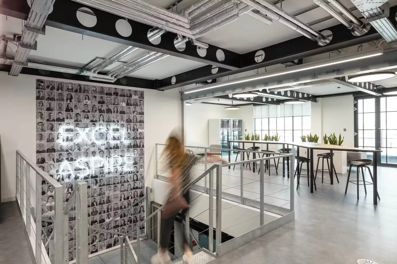 Interior of Checkout.com’s London office with a person walking on the stairs