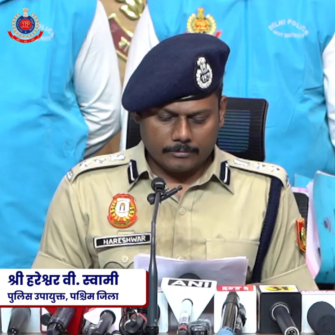 A uniformed Delhi Police officer addresses microphones at the police briefing on the alleged call-centre fraud operation.