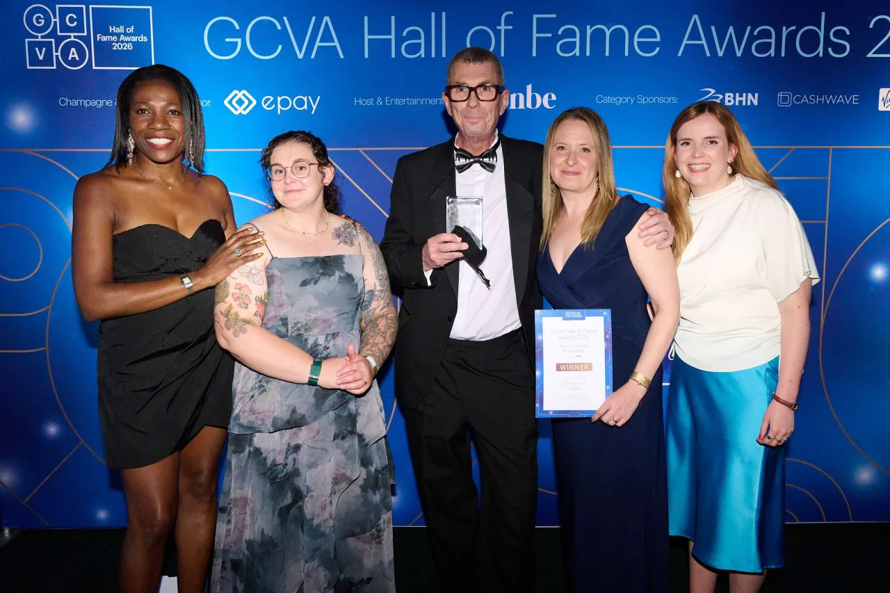 Five attendees pose with an award and certificate in front of the blue GCVA Hall of Fame Awards 2026 backdrop.