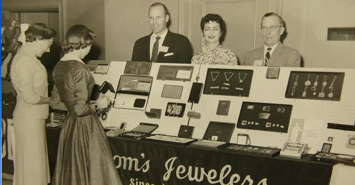 Archive photograph of people viewing jewellery and commemorative items at a Haltom’s display