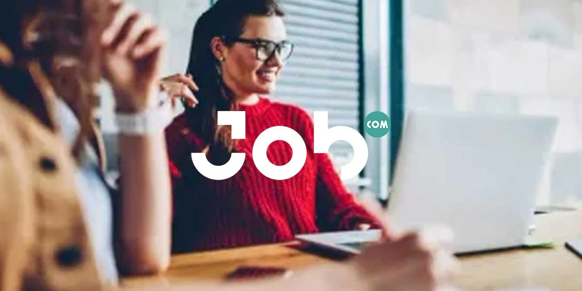 Job.com promotional image of people at a desk with a laptop and the Job.com logo.