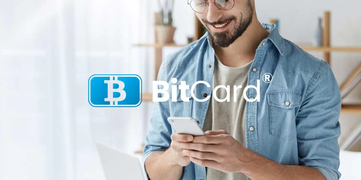 A man using a smartphone in a promotional image bearing the BitCard logo.