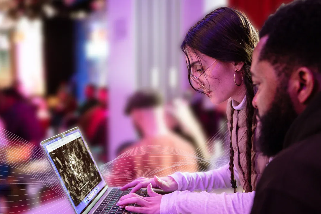 Two people working together on a laptop in Tillo’s official strategy illustration