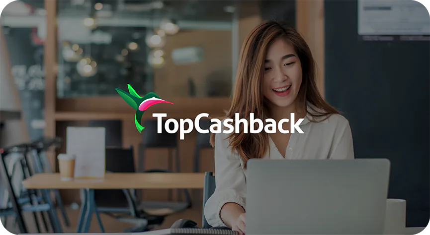 TopCashback logo over a photograph of a woman using a laptop